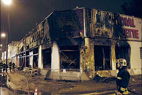 A burned-out shop front in Bondy, Paris